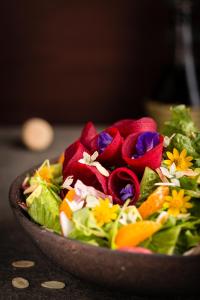 a salad in a wooden bowl on a table at Anantara Angkor Resort in Siem Reap
