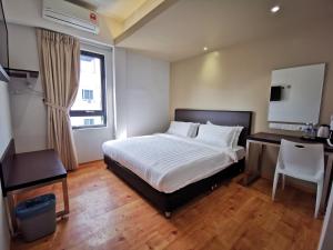 Säng eller sängar i ett rum på D'Green Hotel Kuching