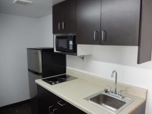 a small kitchen with a sink and a microwave at Motel 6-Portland, TX in Portland