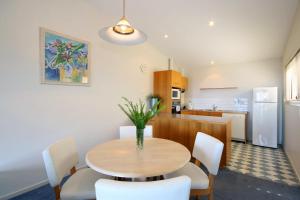 a kitchen and dining room with a table and chairs at Lorne Ocean Sun Apartments in Lorne