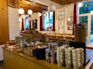 a counter with food and drinks on it in a restaurant at Auberge Pour Tous in Vallorbe