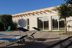 a group of lawn chairs and a swimming pool at Villetta di Nonna Giovanna in Marsala +24 photos