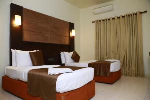 a hotel room with two beds in a room at Sea Port in Negombo