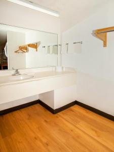 a bathroom with a sink and a mirror at OYO Hotel Centralia in Centralia