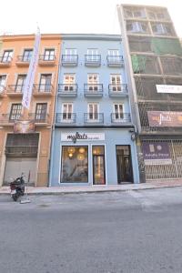 a large building with a store on a street at MyFlats Luxury Downtown in Alicante