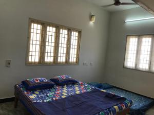 a bedroom with a bed with two pillows on it at Bethel house in Chennai