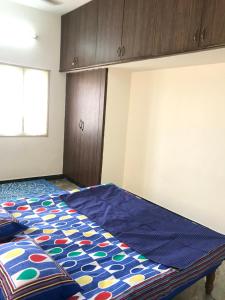 a bedroom with a bed with a colorful blanket on it at Bethel house in Chennai