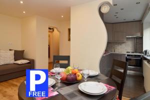 a dining room table with a bowl of fruit on it at Tomsona Apartment Riga Center in Rīga