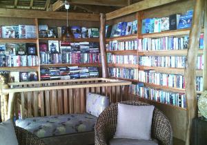 a room with a book shelf filled with books at JJS BACKPACKERS VILLAGE in Siquijor