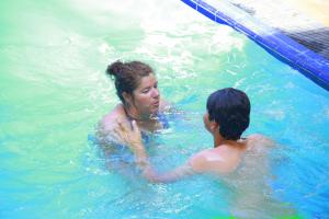 a woman and a child in a swimming pool at Sea Port in Negombo