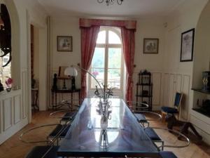 a living room with a table and a window at Château de la Bucaille - entier in Aincourt