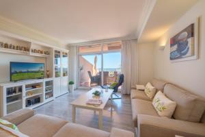 a living room with a couch and a table at Edificio Magna Marbella in Marbella