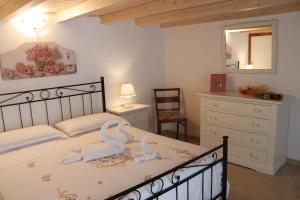 a bedroom with a bed with swans on it at Apartment da Rosa in San Vito dei Normanni