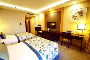 Postel nebo postele na pokoji v ubytování Beijing Yun-zen Jinling Lotus Hotel