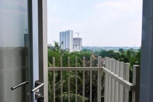 a balcony with a view of a city at Brand New Studio Room at Bintaro Icon Apartment By Travelio in Tangerang