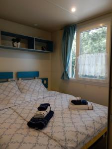 a bedroom with a bed with two towels on it at Tiny house Dora in Marčana