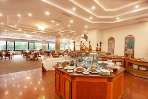 a restaurant with plates of food on a buffet at Ozkaymak Konya Hotel in Konya