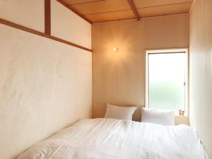 Postel nebo postele na pokoji v ubytování Y Pub & Hostel Tottori