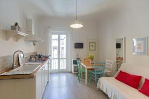 a kitchen and living room with a couch and a table at Piazza del Mercato Centrale in Florence