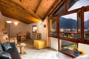 a living room with a couch and a large window at B&B Garzola in Ossuccio