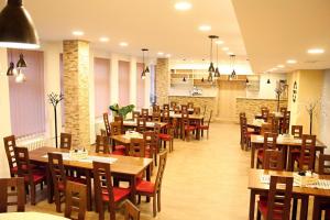 a dining room with wooden tables and chairs at SPORTHOTEL Milevsko in Milevsko
