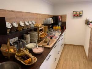 a kitchen with a long counter with lots of food at Haus Salzburgerland in Altenmarkt im Pongau