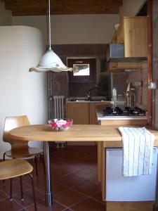 a kitchen with a wooden table in a kitchen at Torre Tanquián Eco Finca - Ribeira Sacra in Pantón