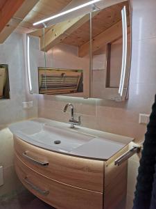 a bathroom with a sink and a mirror at Ferienhaus Elisabeth in Forstau