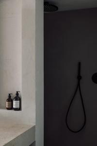a bathroom with two bottles on a wall at OKU Ibiza in San Antonio