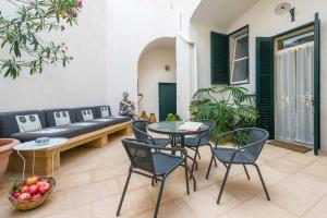 a living room with a couch and a table and chairs at Palazzo Tre Cardi in Salve