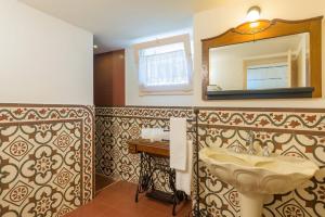 a bathroom with a sink and a mirror at Palazzo Tre Cardi in Salve