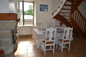 a dining room with a table and two chairs at IDAVRO in Saint-Nicolas-du-Pélem