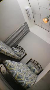 a room with two chairs and a bed and a lamp at Josh's garage 2.0 Lost World Tambun for 8-10pax in Ipoh