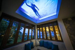 ein Wohnzimmer mit einem großen TV an der Decke in der Unterkunft Kundala Beach Resort Hua Hin in Hua Hin