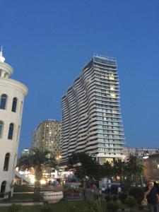 a tall building in a city at night at Batumi - Orbi Sea Tower & Residence in Batumi