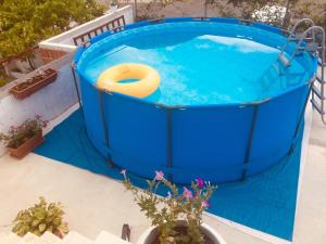 a large blue pool with a yellow raft in it at Aparthotel Monterria in Bar