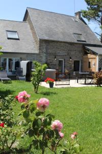 a house with pink flowers in the yard at Au Mont Chez Nous # Jacuzzi & Sauna # in Pontorson