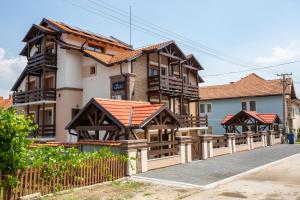 a house with a wooden fence in front of it at Vila Almax in Soko Banja