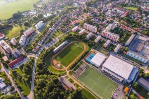 an aerial view of a city with a tennis court at SPORTHOTEL Milevsko in Milevsko