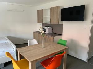 a small room with a table and chairs at Mikulov Inn - Apartments Slunce in Mikulov