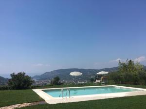 a swimming pool in the middle of a grassy field at BellaVista Relax - Adults Only in Costermano