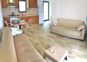a living room with a couch and a table at Oliva Casa Datça in Datca