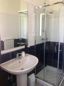 a bathroom with a sink and a glass shower at La Casa di Anna in Delebio +15 photos
