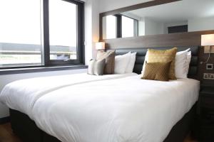 a hotel room with two beds and a window at Haymarket Hub Hotel in Edinburgh
