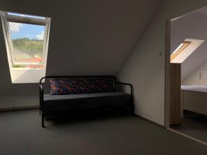 a bed in a room with a window at Mikulov Inn - Apartments Slunce in Mikulov