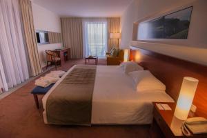 a hotel room with a large bed in a room at Azoris Faial Garden – Resort Hotel in Horta