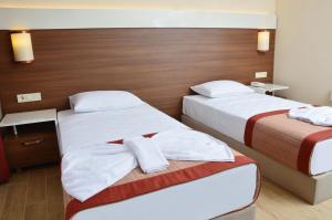 Postel nebo postele na pokoji v ubytování Sunway Club Otel