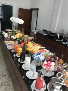 a buffet with many plates of food on a table at Villas Hotel in Santo Ângelo