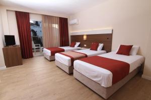 Postel nebo postele na pokoji v ubytování Sunway Club Otel