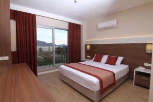 Postel nebo postele na pokoji v ubytování Sunway Club Otel